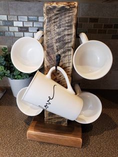 coffee cups and saucers sitting on top of a wooden stand