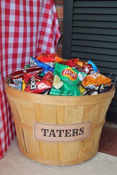 a wooden basket filled with chips sitting on top of a table