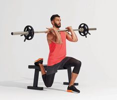 a man squats on a bench with a barbell in front of his face