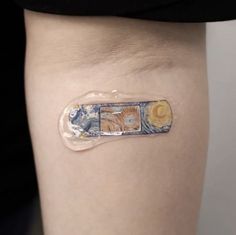 a woman's thigh with an adhesive tape on it that has images of the sun, earth and moon