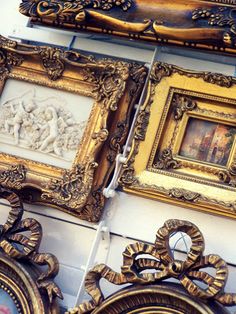 ornate gold framed pictures hang on the wall