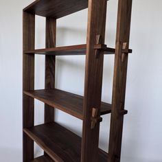 a wooden shelf with three shelves on each side