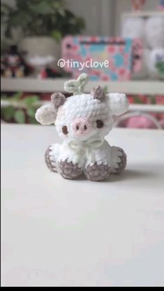 a small crocheted cow sitting on top of a table