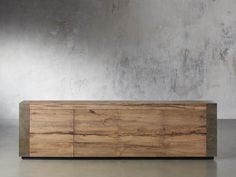 a large wooden cabinet sitting on top of a cement floor