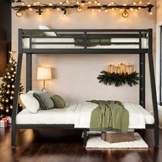 a bunk bed with lights on the ceiling and a christmas tree in the corner next to it