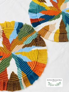 two woven baskets with different colors and designs on the sides, sitting side by side