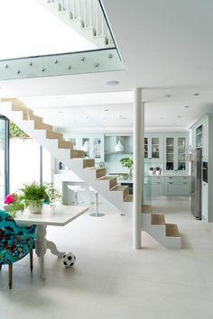 a living room filled with furniture and a staircase