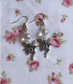 ✨Gorgeous holographic fairy earrings, these reflect a pinkish/rainbow aura upon wearing. These earrings are made with metal safe for sensitive ears <3 perfect for any occasion and also a very heartfelt gift for your fairy friends 💗✨  Fairycore, Handmade Jewelry, y2k, Fairy Earrings, Aura, Whimsical Jewelry, Cottagecore Jewelry  All jewelry orders come with a custom care guide⭐️ For any questions, please message me! Silver Fairycore Earrings For Party, Fairycore Silver Earrings For Gift, Silver Fairy Earrings For Party, Silver Fairycore Drop Earrings, Silver Fairy Style Party Earrings, Fairy Grunge Dangle Earrings Gift, Fairy Style Drop Earrings, Fairycore Drop Earrings, Silver Fairy Dangle Earrings