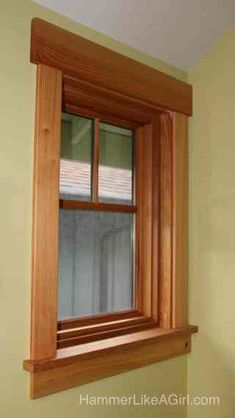 a wooden window frame in the corner of a room