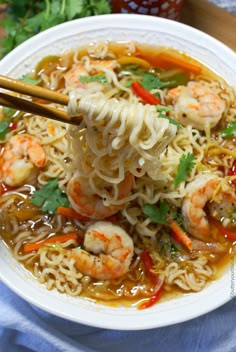 shrimp and noodle soup in a white bowl with chopsticks