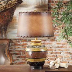 a lamp that is on top of a table next to a brick wall and tree