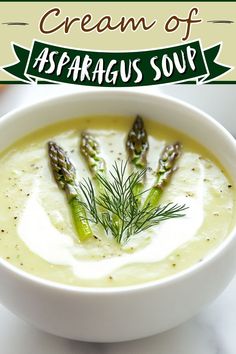 a white bowl filled with asparagus soup on top of a table