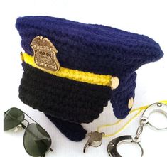 a police hat, sunglasses and keychain on a white background