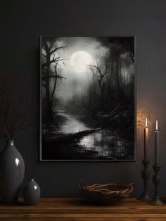 a black and white painting on a wall next to candles