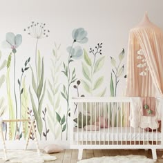 a baby's room decorated in pink and green with flowers on the wall, crib