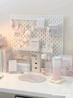 a white desk topped with lots of items