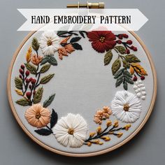 an embroidery pattern with flowers and leaves on it, in front of the words hand embroidery pattern