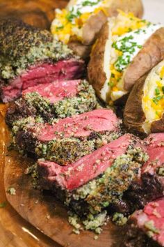 steak and potatoes on a cutting board with parsley sprinkled on the top