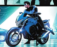 a man riding on the back of a blue motorcycle