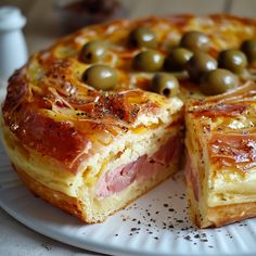 a ham and olive pie on a white plate