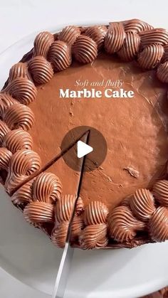 there is a cake with chocolate frosting on the top and an arrow in the middle