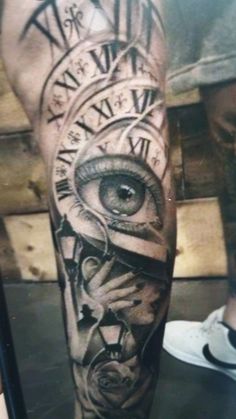 a man's leg with an eye and clock on it