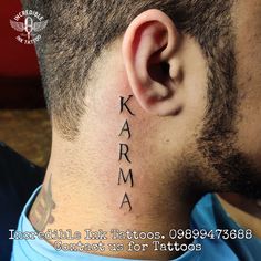 a man's neck with the word karma tattooed on his left side behind his ear