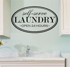 a bathroom wall decal that says self serve laundry open 24 hours