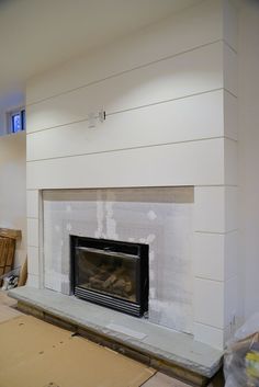 the fireplace is being painted white and ready to be installed in the living room or dining room