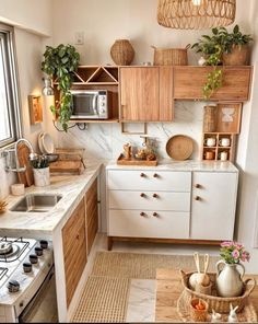 a kitchen filled with lots of wooden cabinets and counter top space next to a window