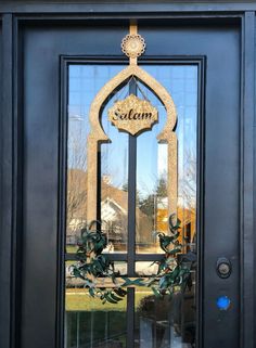 the front door is decorated with a wreath and an ornate glass sign that reads salem