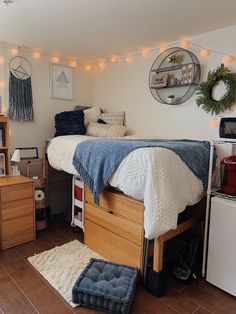 a bed room with a neatly made bed and lots of lights on the wall above it