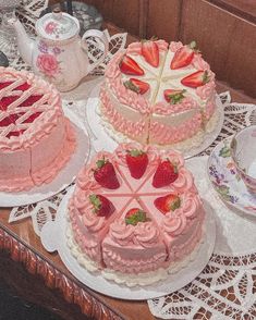 there are three cakes on the table and one has strawberries on it as well