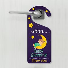 a door hanger with a baby sleeping on the moon