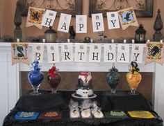 a birthday party with decorations on the mantle and table cloths in front of it