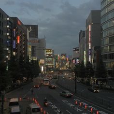 the city street is busy with cars and buildings