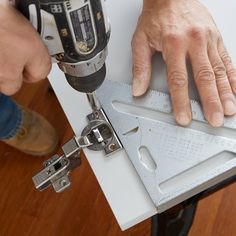 a person using a driller on a piece of metal