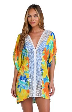 Model is wearing a blue Vibrant Print V-neck Kaftan For Beachwear, Spring Beach Party Cover-up With Crochet Trim, Beachy V-neck Floral Print Beach Dress, Bohemian V-neck Swimwear For Spring, V-neck Summer Cover-up For Spring, Multicolor V-neck Cover-up For Beach Party, Beachy Multicolor V-neck Cover-up, Summer V-neck Tunic With Vibrant Print, Flowy Multicolor Tunic Cover-up