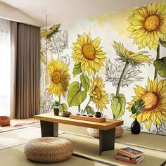 a living room with sunflowers painted on the wall and coffee table in front