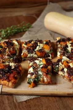 several slices of pizza on a cutting board