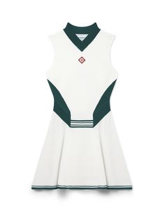 a white dress with green trims on the neck and collar, in front of a white background