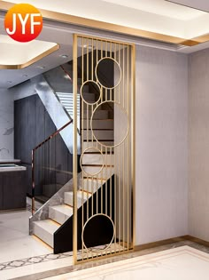 the interior of a modern home with stairs and marble flooring is decorated in gold