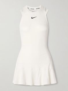 Nike's 'Slam' tennis dress is designed to boost your style and performance on the court. Made from moisture-wicking Dri-FIT, it has a ribbed finish, comfortable elasticated waistband and a built-in bra for support. Cutouts at the back provide extra ventilation. Tennis Looks Women, White Stretch Athleisure Dress, Fitted White Tennis Dress For Sports, White Athleisure Tennis Dress For Workout, White Athleisure Tennis Dress For Sports, White Athleisure Tennis Dress, White Tennis Dress In Athleisure Style, White Tennis Dress For Spring Workout, White Fitted Athletic Dress