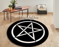 a black and white circular rug with an inverted pentagram symbol on the center in front of a wooden floor