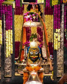 the statue is decorated with flowers and garlands