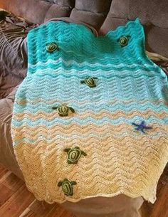 a crocheted blanket with sea shells on it is displayed in an instagramtion