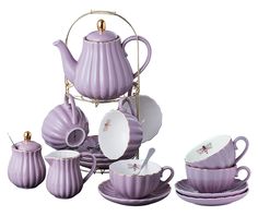 a purple tea set with matching cups and saucers