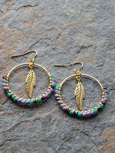 "Beaded Hoop earrings - wire wrapped hoops - feather earrings - colorful bohemian jewelry -  boho style - free spirit - purple - blue - green My signature style, colorful wire wrapped beaded hoop earrings, with a twist. To create these colorful earrings I take slender circular findings and precision wire wrap them with colorful glass, stone, or crystal beads. This pair, features a single hoop wrapped with colorful czech glass beads. In the center I've added a gold plated feather charm. Ships pre Diy Wire Earrings, Boho Hoop Earrings, Colorful Bohemian, Earrings Wire, Earrings Inspiration, Handmade Wire Jewelry, Homemade Jewelry, Colorful Earrings, Beaded Hoop Earrings