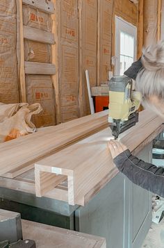 a person using a machine to cut wood