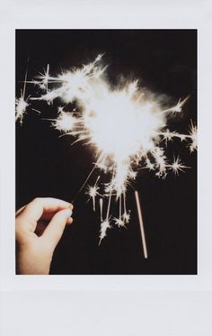 a person holding a sparkler in their hand